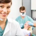 female hygienist in foreground